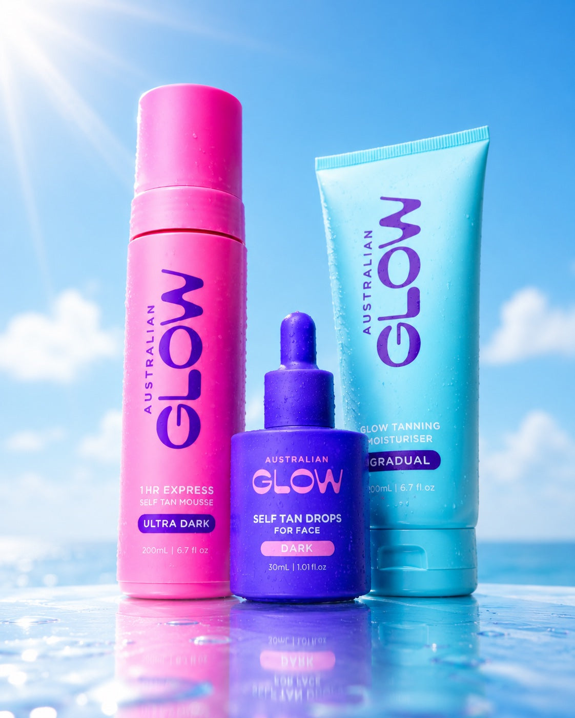 The Glow Up trio close together against the summer sky — mousse, drops and Gradual