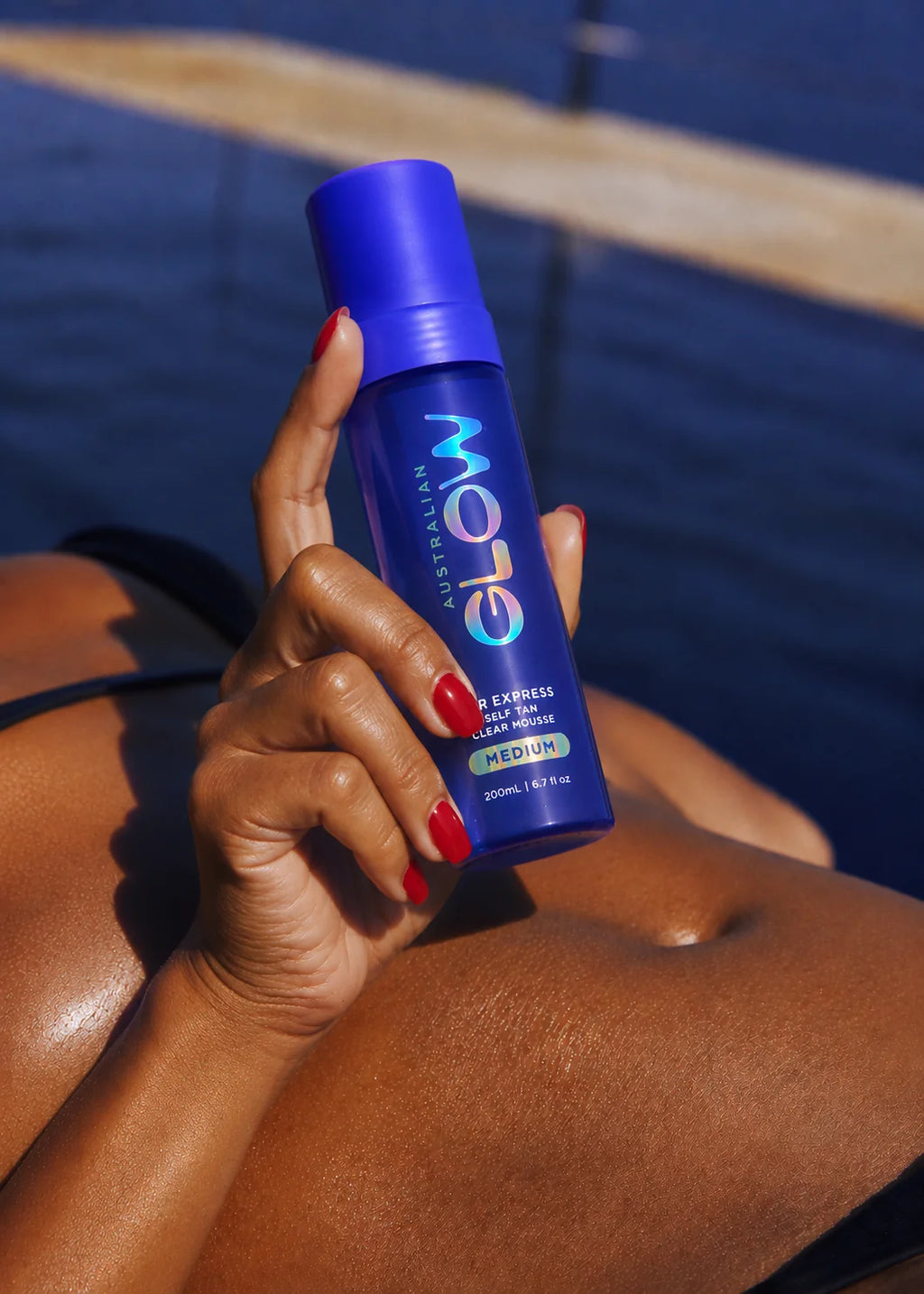 Clear Mousse held poolside over sun-warmed skin