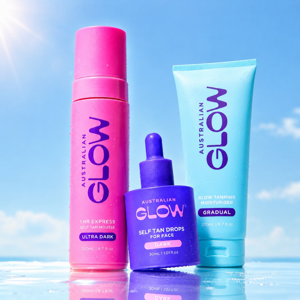 The Glow Up contents against a summer sky — Ultra Dark Express Mousse, Face Tan Drops and Gradual Tanning Moisturiser